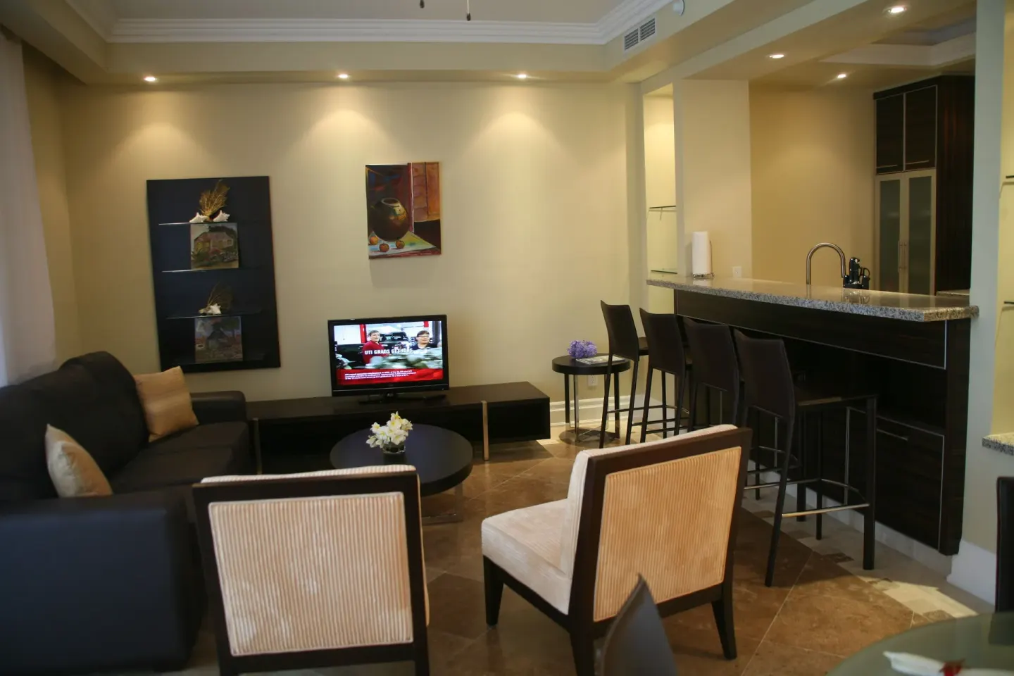 One Bedroom Condo living area with sofa and kitchen bar at The Atrium Resort.