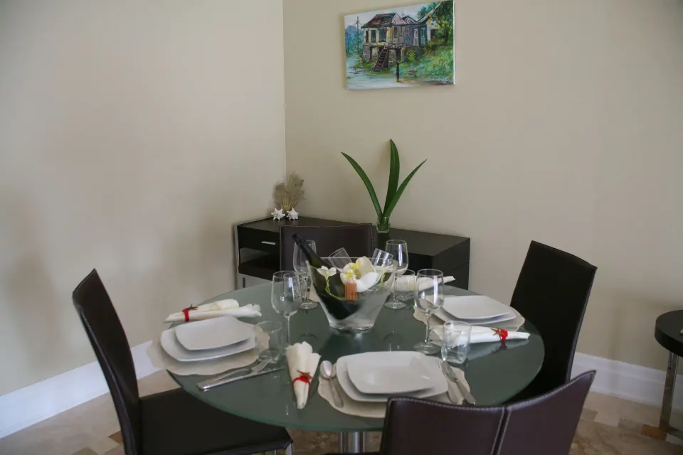 Premium Condo 1 Bedroom dining table set for four at The Atrium Resort.