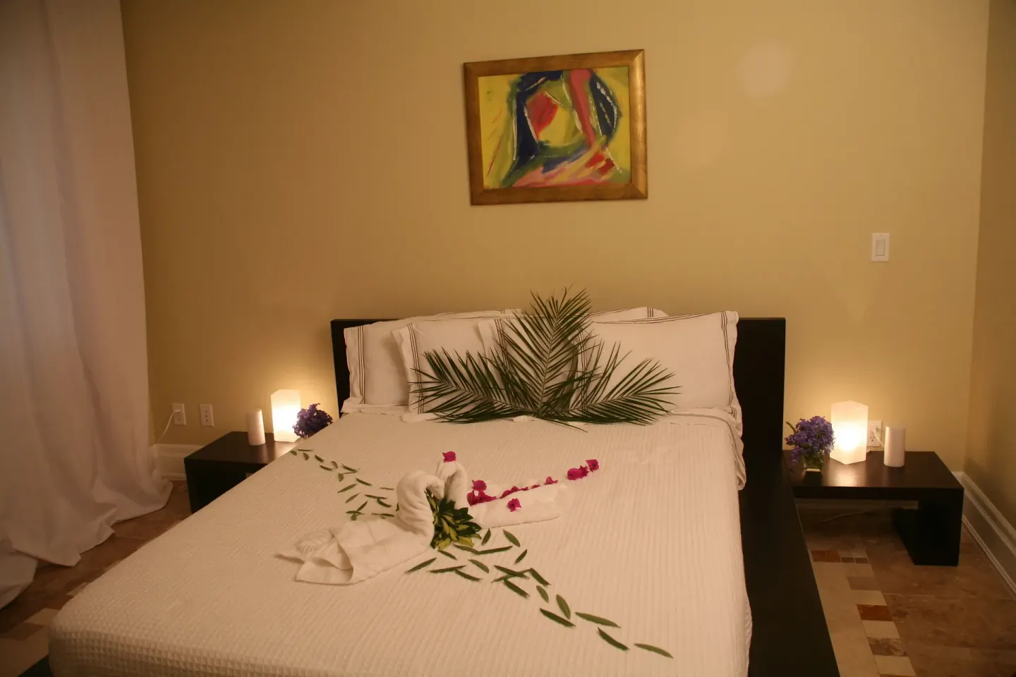 Premium Condo 1 Bedroom bed with floral decor and bedside lamps at The Atrium Resort.