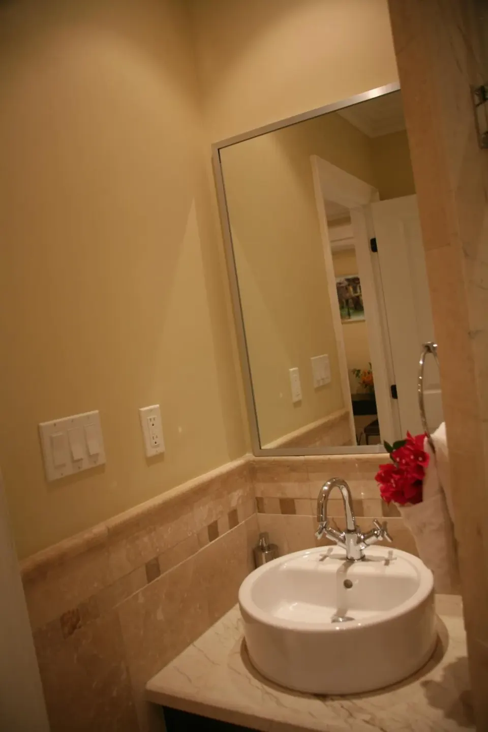 Studio bathroom vanity with vessel sink and wall mirror at The Atrium Resort.