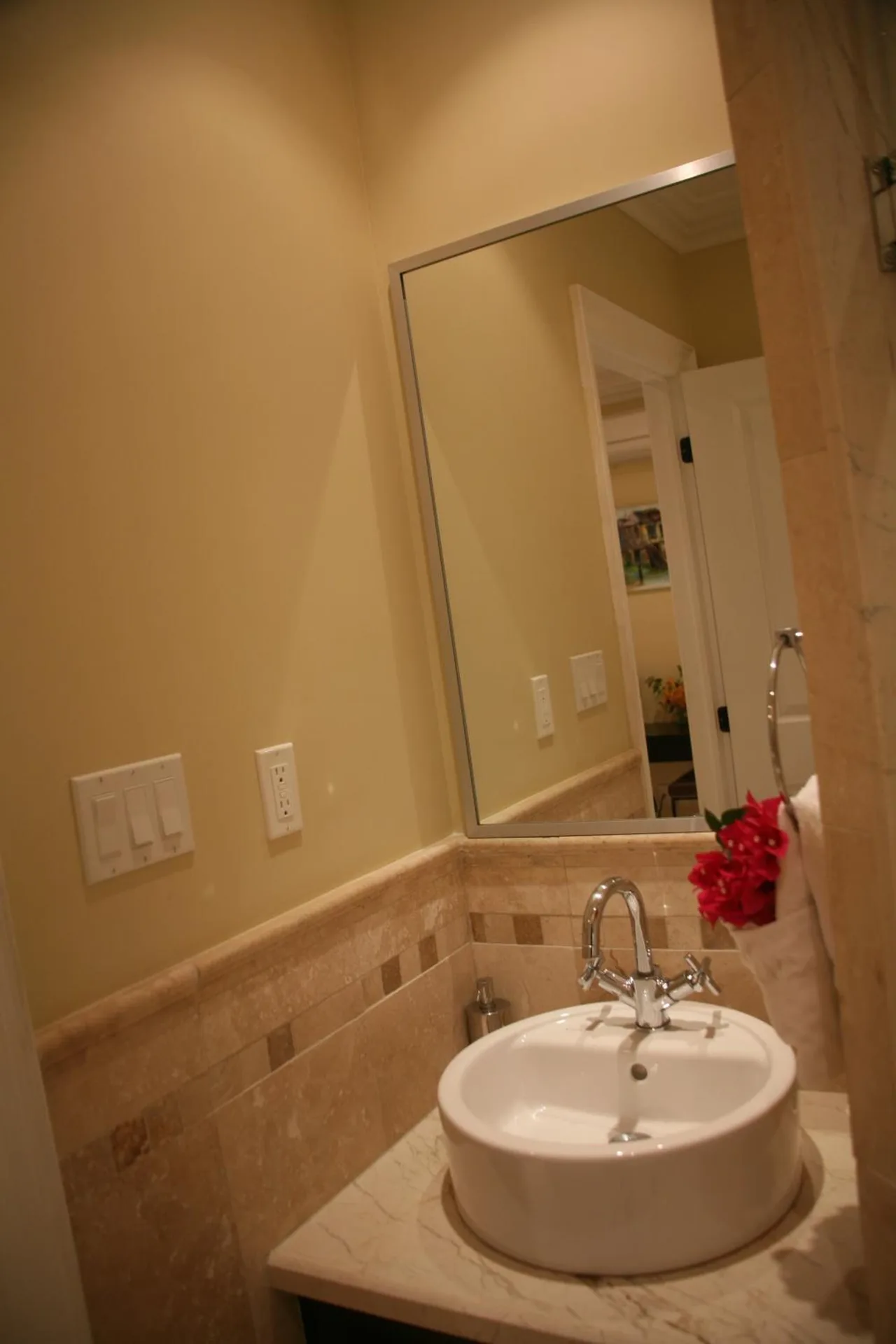 Studio bathroom vanity with vessel sink and wall mirror at The Atrium Resort.