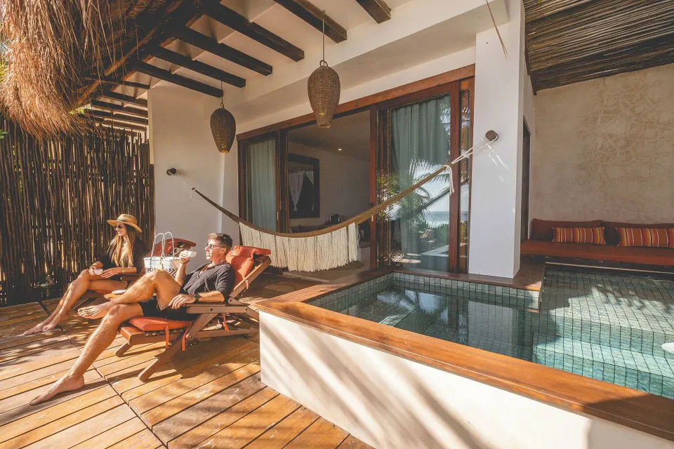 Deck with lounge chairs, hammock and private plunge pool outside a suite at The Beach Tulum