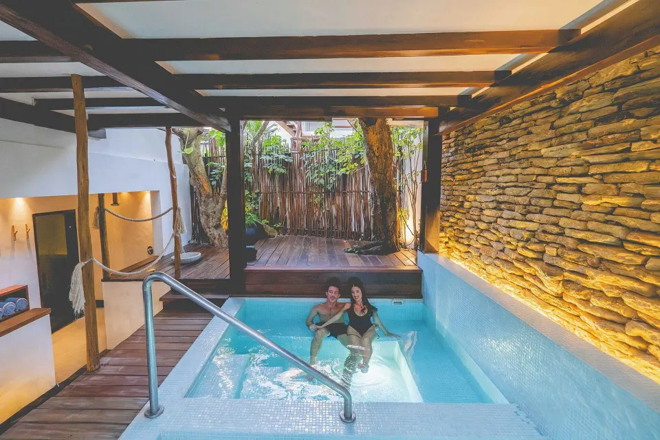 Two guests relaxing in a small private pool at The Beach Tulum