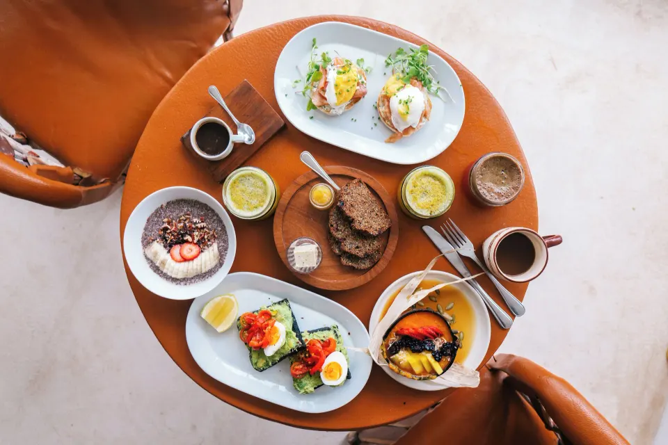 Overhead breakfast spread on a small table at The Beach Tulum