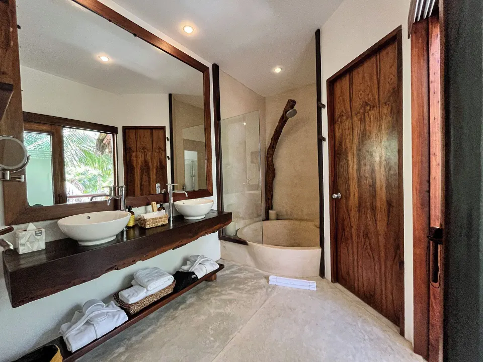 Bathroom with double vanity and freestanding tub in a Beachfront Rooftop room at The Beach Tulum