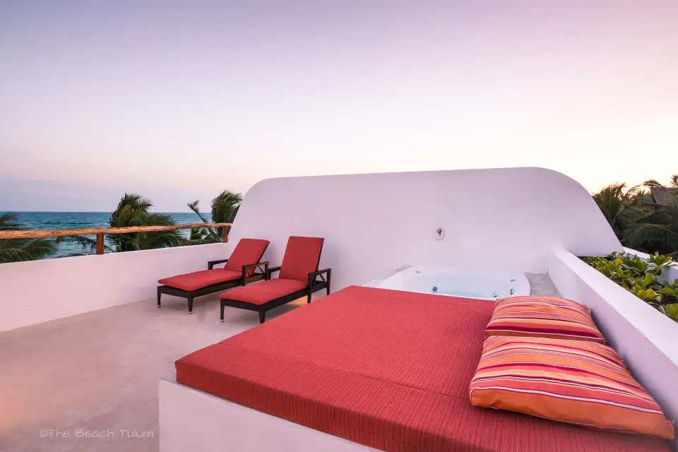 Rooftop daybed, loungers and ocean horizon at The Beach Tulum