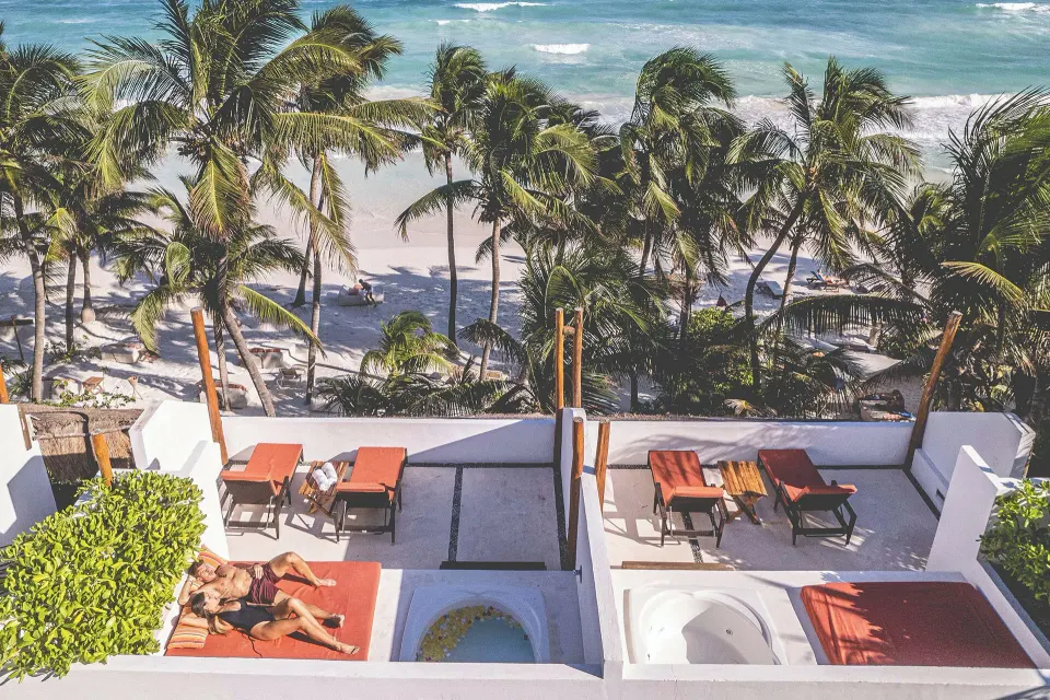 Rooftop terrace with loungers and ocean view at The Beach Tulum
