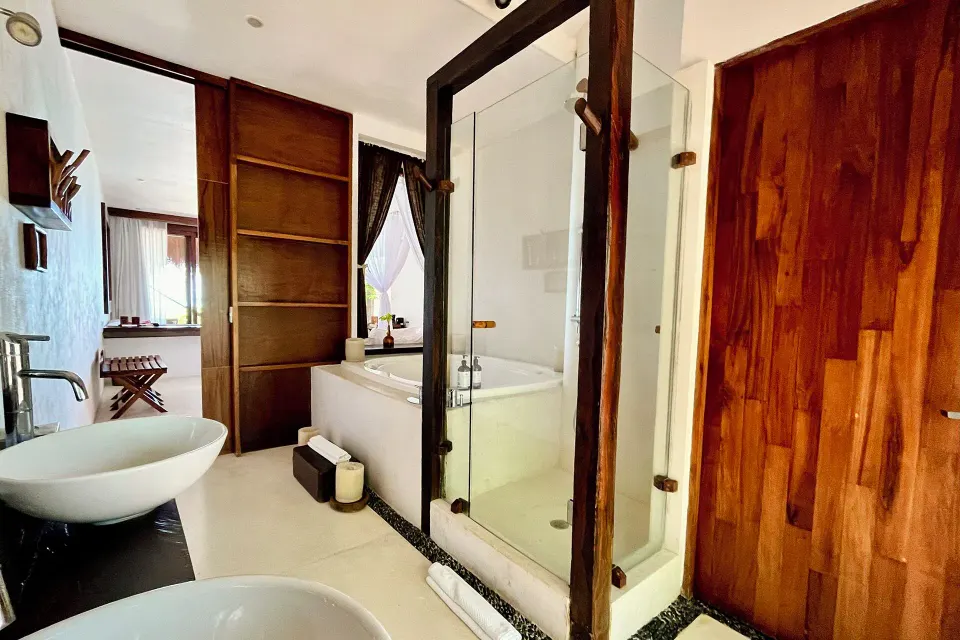 Bathroom with dual sinks and a freestanding bathtub in a Junior Suite at The Beach Tulum.
