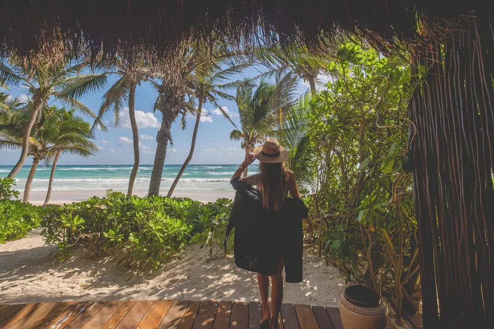 View from a Junior Suite deck out to the beach and palms at The Beach Tulum.