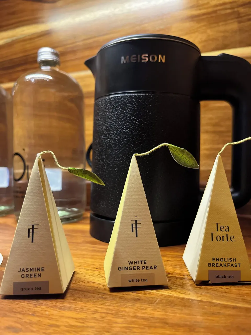 Tea and coffee amenities arranged on a wooden counter in a suite at The Beach Tulum
