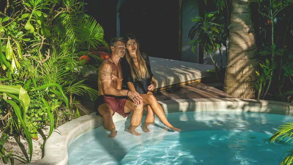 Couple relaxing in a private pool surrounded by tropical foliage at The Beach Tulum