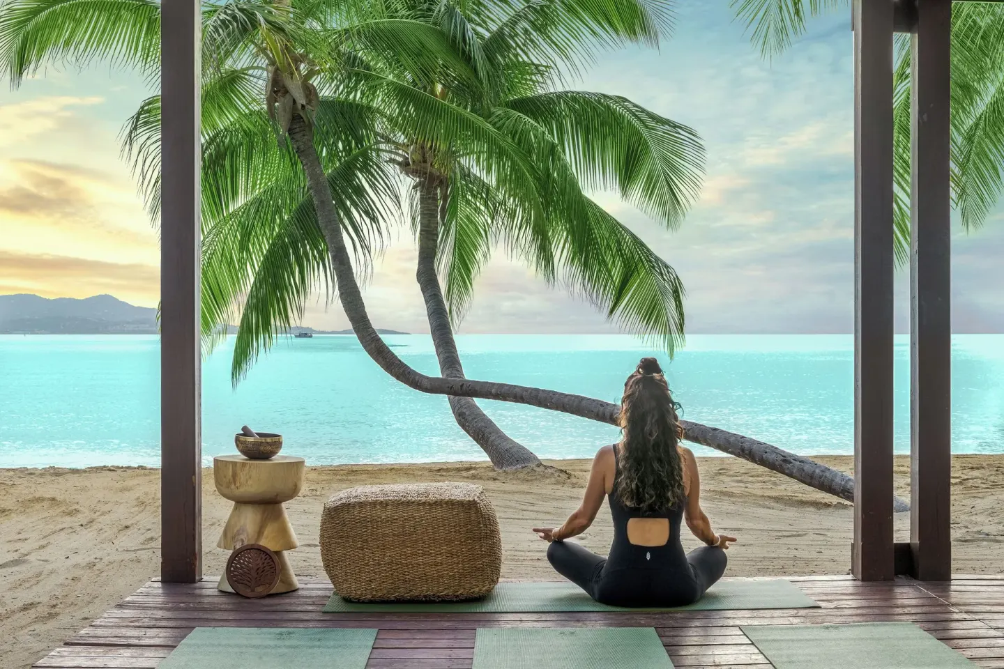 A person meditating on a beachfront deck at The Buccaneer Beach & Golf Resort.