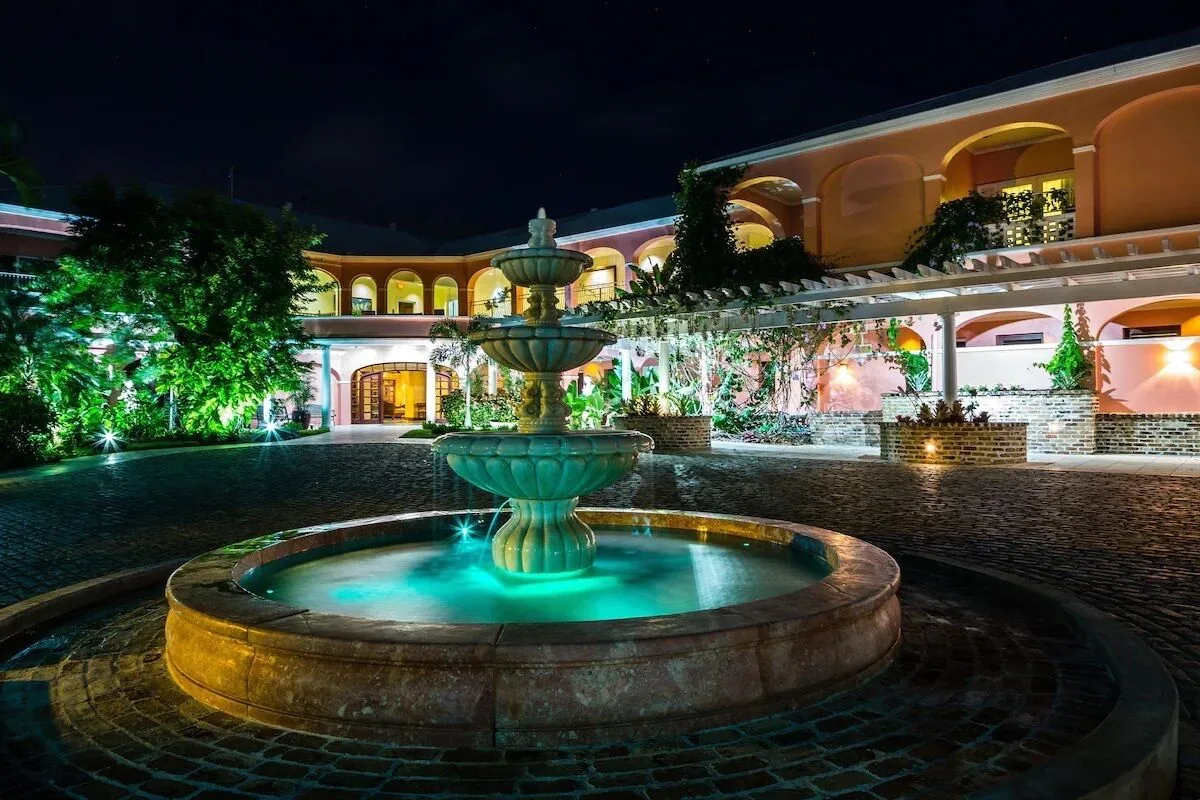 Illuminated courtyard fountain at night at The Buccaneer Beach & Golf Resort.