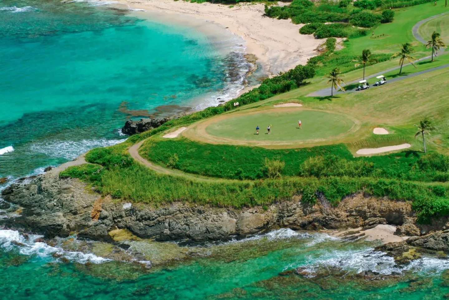 Aerial view of a seaside golf green at The Buccaneer Beach & Golf Resort.