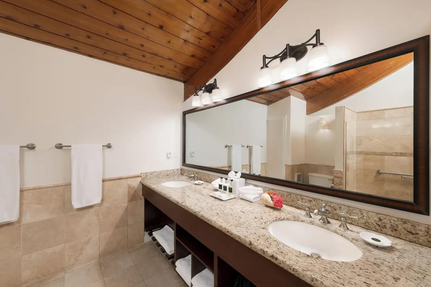 Deluxe Oceanfront garden-view bathroom at The Buccaneer Beach & Golf Resort with double vanity and mirror