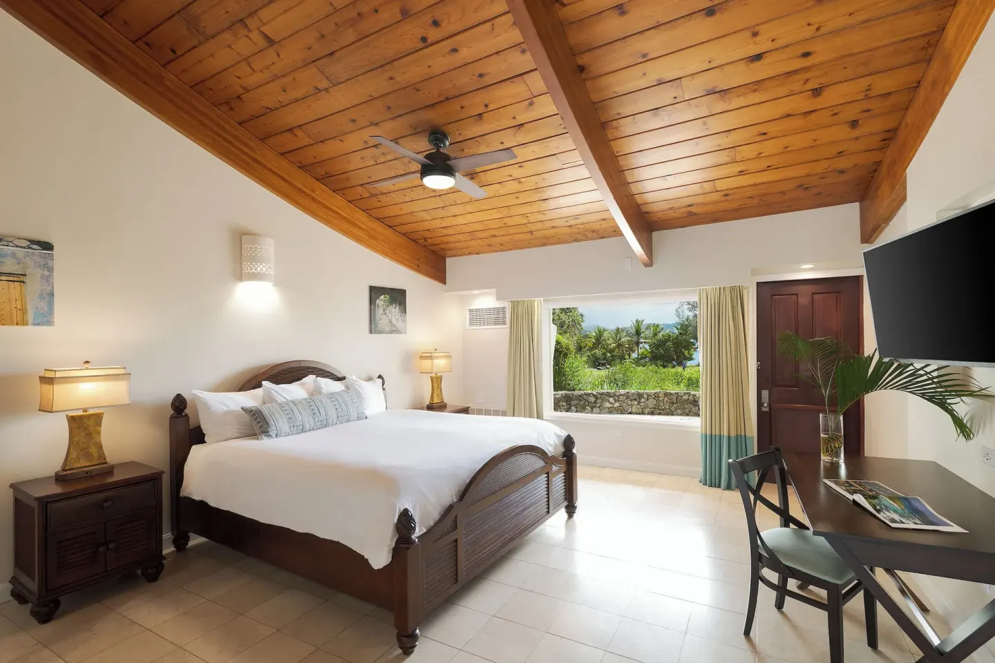 Deluxe Oceanfront garden-view king room at The Buccaneer Beach & Golf Resort with wood ceiling and window
