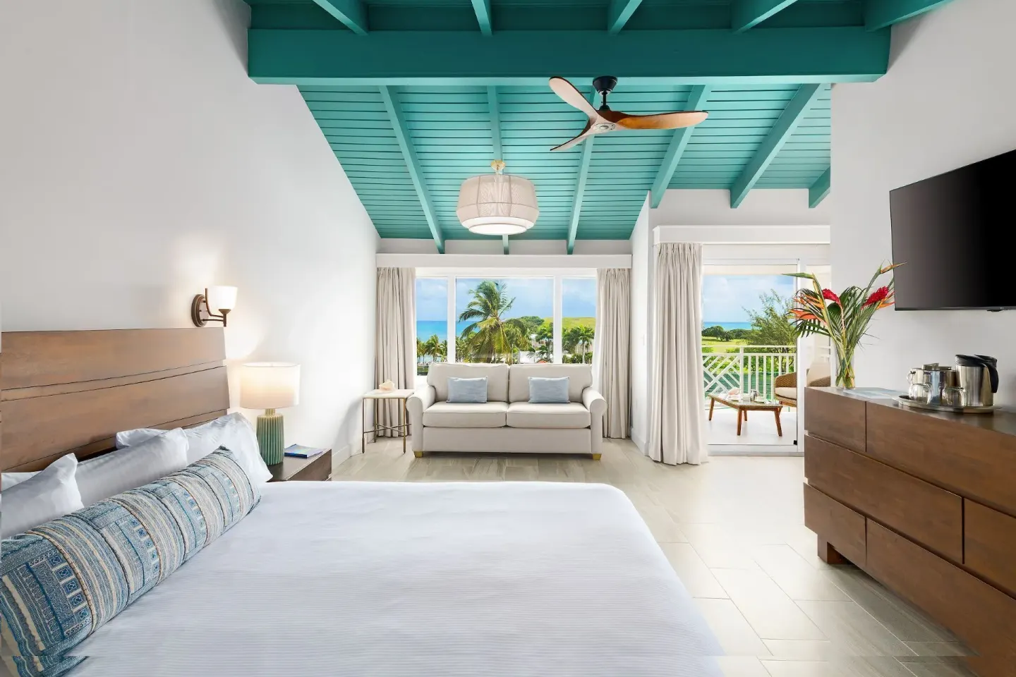 Deluxe Ocean View room with king bed and balcony at The Buccaneer Beach & Golf Resort.