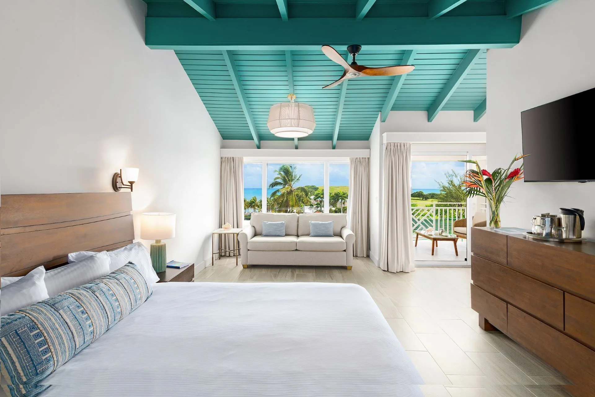 Deluxe Ocean View room with king bed and balcony at The Buccaneer Beach & Golf Resort.
