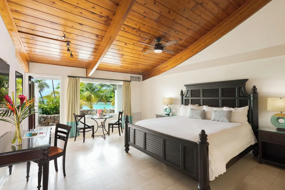 Deluxe Oceanfront room with king bed and terrace at The Buccaneer Beach & Golf Resort.