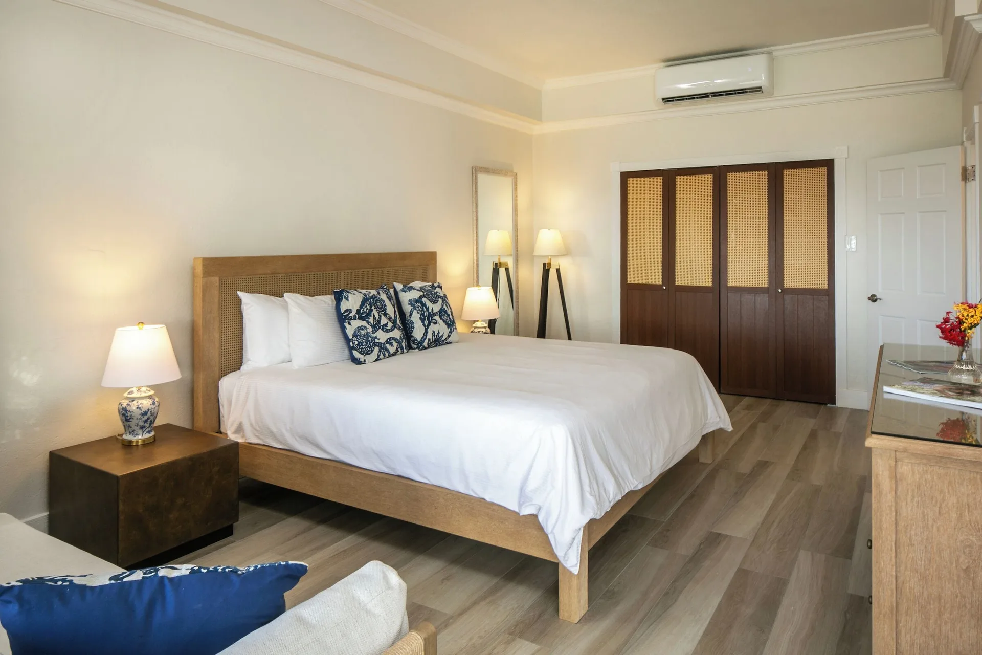 Family Cottage Suite king bedroom with wardrobe and dresser at The Buccaneer Beach & Golf Resort.