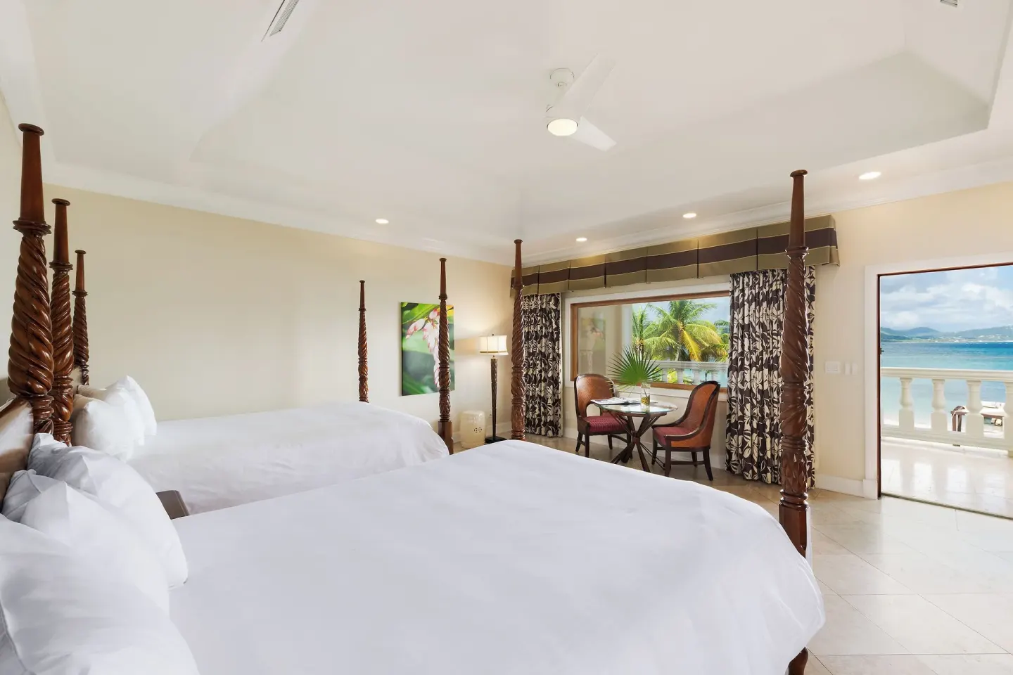Luxury Room Beachside with two four-poster beds at The Buccaneer Beach & Golf Resort.