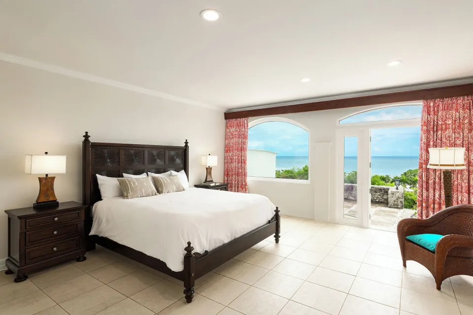 Luxury Ocean View room with king bed and sea-facing doors at The Buccaneer Beach & Golf Resort.