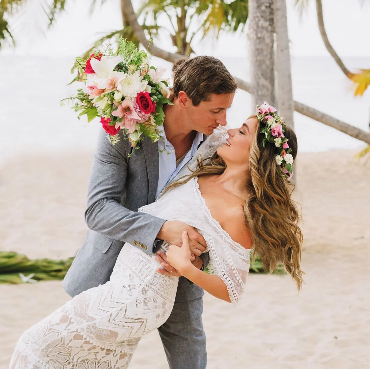 Bride and groom posing on the beach at The Buccaneer Beach & Golf Resort.