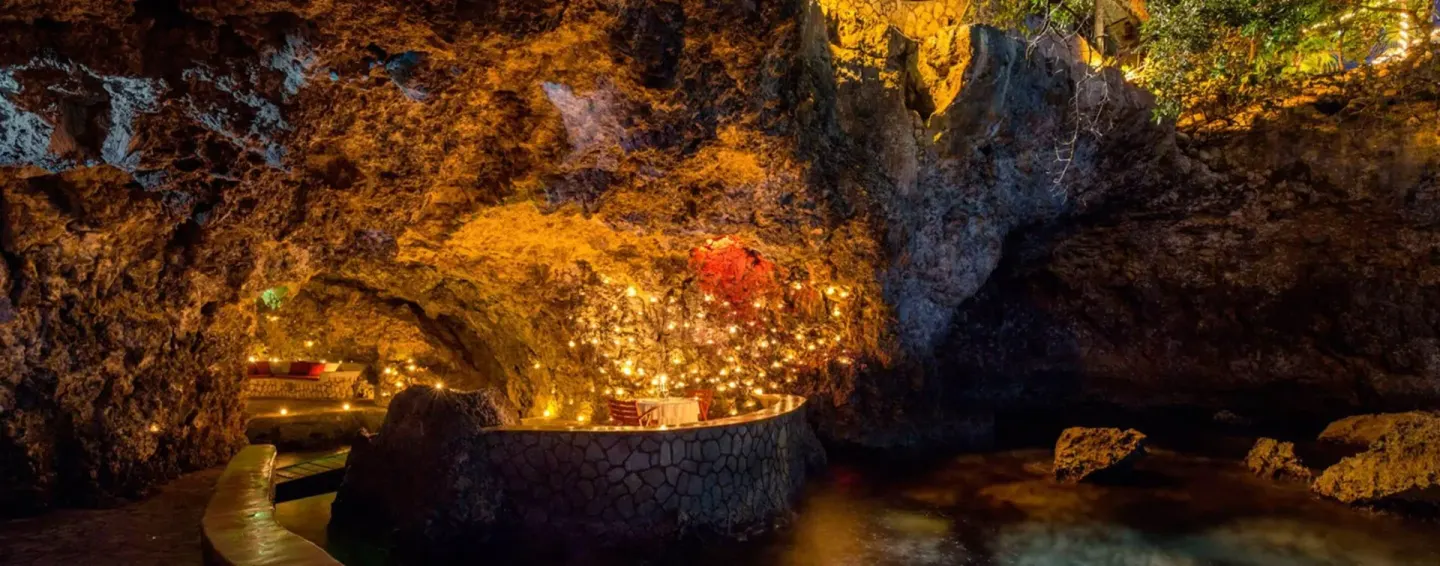 Illuminated cave bar built into the cliffside at The Caves.