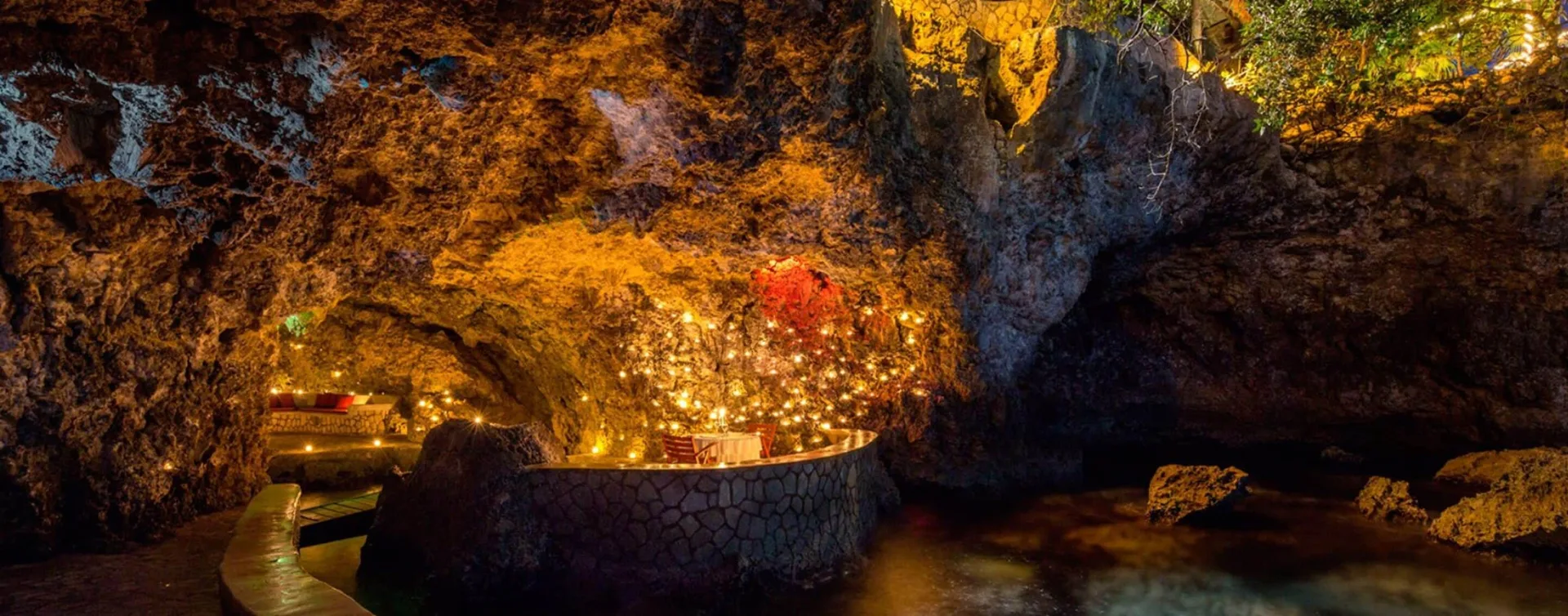 Illuminated cave bar built into the cliffside at The Caves.