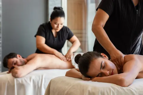 Two guests receive side-by-side massages at The Club at Solaz.