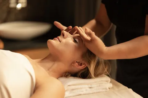 A guest receives a facial massage treatment at The Club at Solaz.