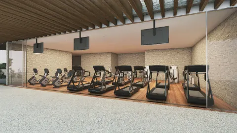 Fitness room with treadmills and bikes against stone walls at The Club at Solaz.