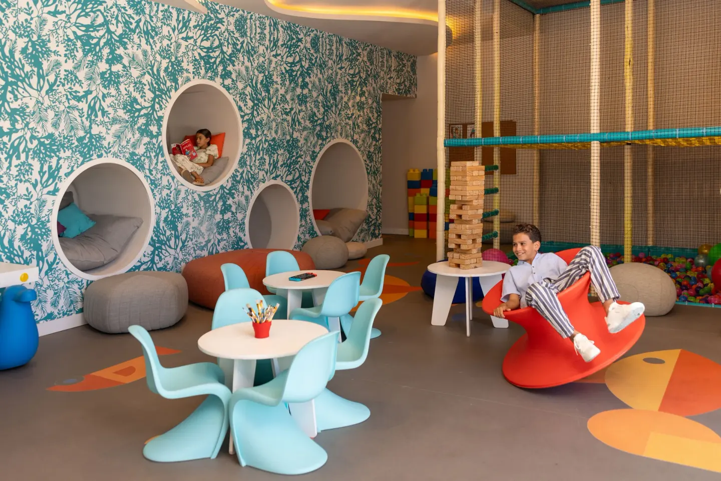 Children play in a colorful kids club room at The Club at Solaz.