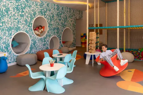 Children play in a colorful kids club room at The Club at Solaz.