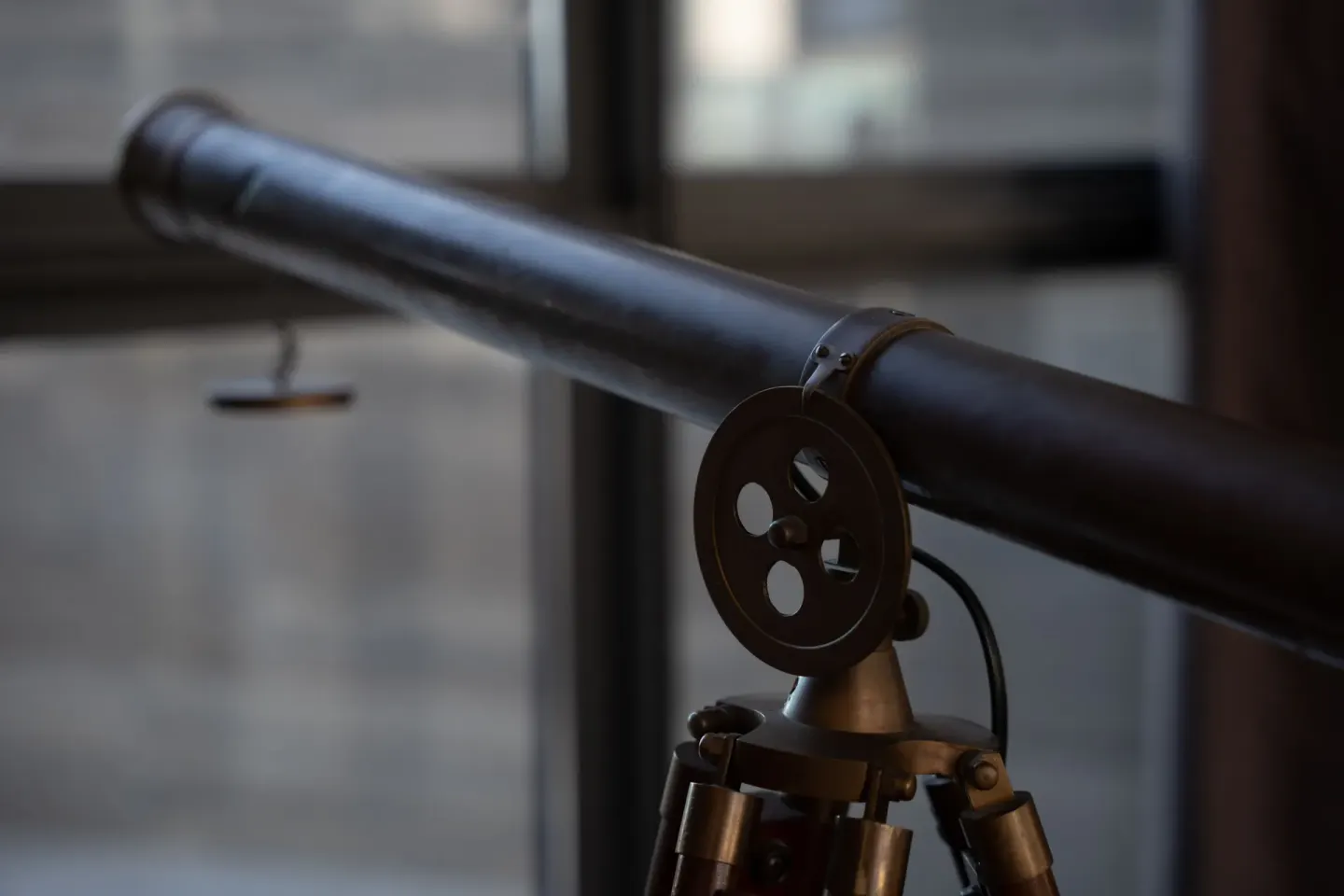 Close-up of a mounted telescope near windows at The Club at Solaz.