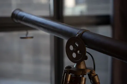 Close-up of a mounted telescope near windows at The Club at Solaz.