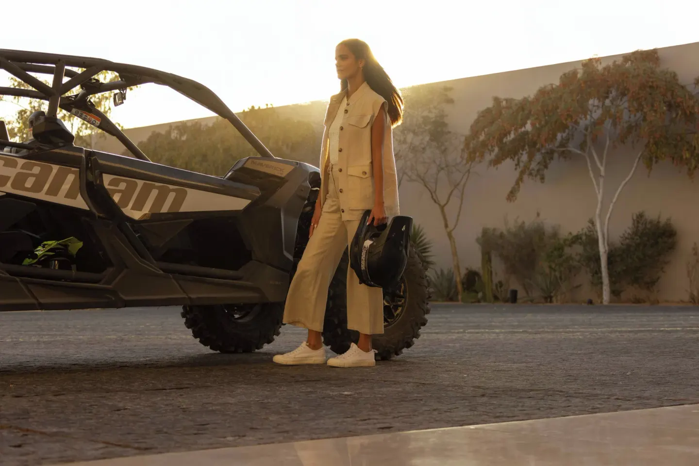 Guest stands beside an off-road vehicle at sunset at The Club at Solaz.
