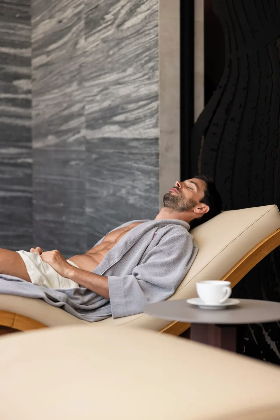A guest relaxes on a spa lounge chair at The Club at Solaz.