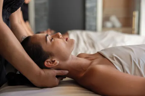 Close-up of a spa neck massage on a treatment bed at The Club at Solaz.