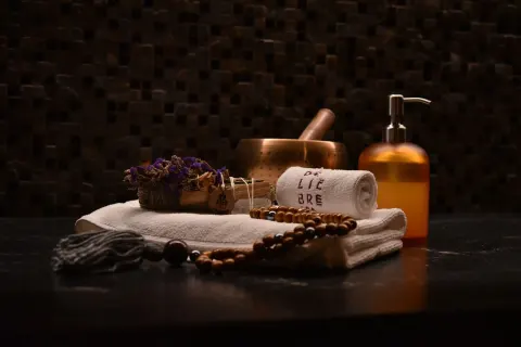 Spa towels, a bowl, beads, and a pump bottle at The Club at Solaz.
