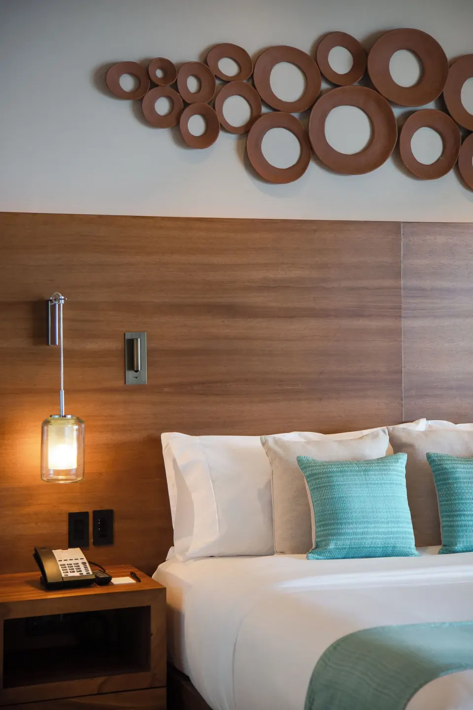 Close-up of the king bed and bedside table in a One Bedroom Villa at The Club at Solaz.