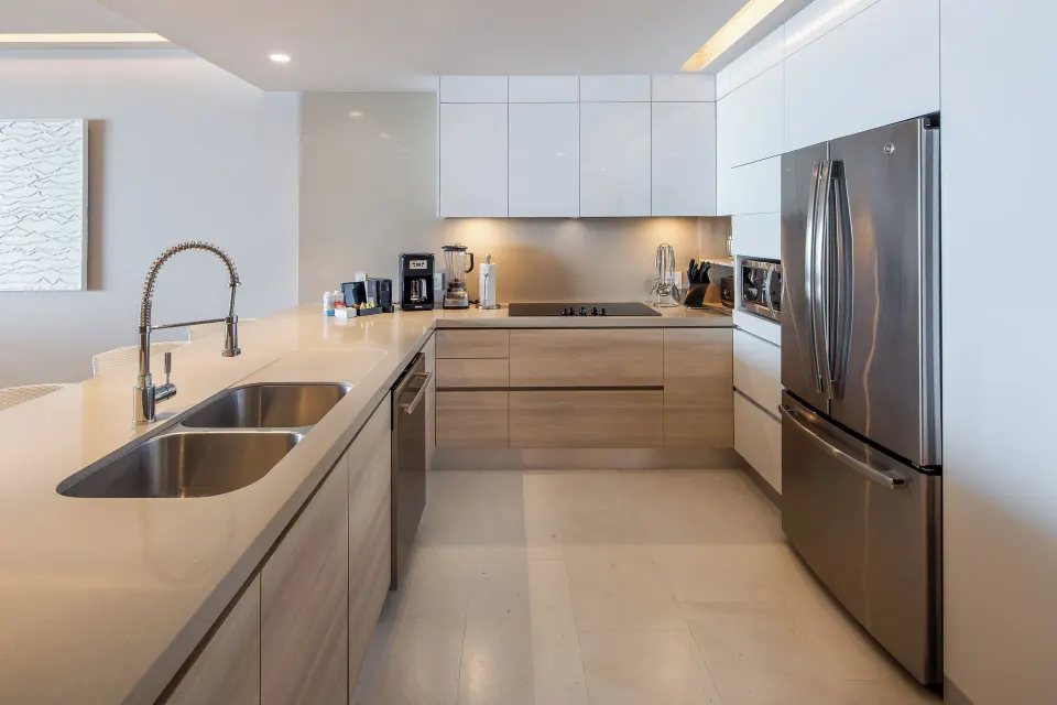 Modern kitchen in a One Bedroom Villa Ocean View at The Club at Solaz with sink and refrigerator.