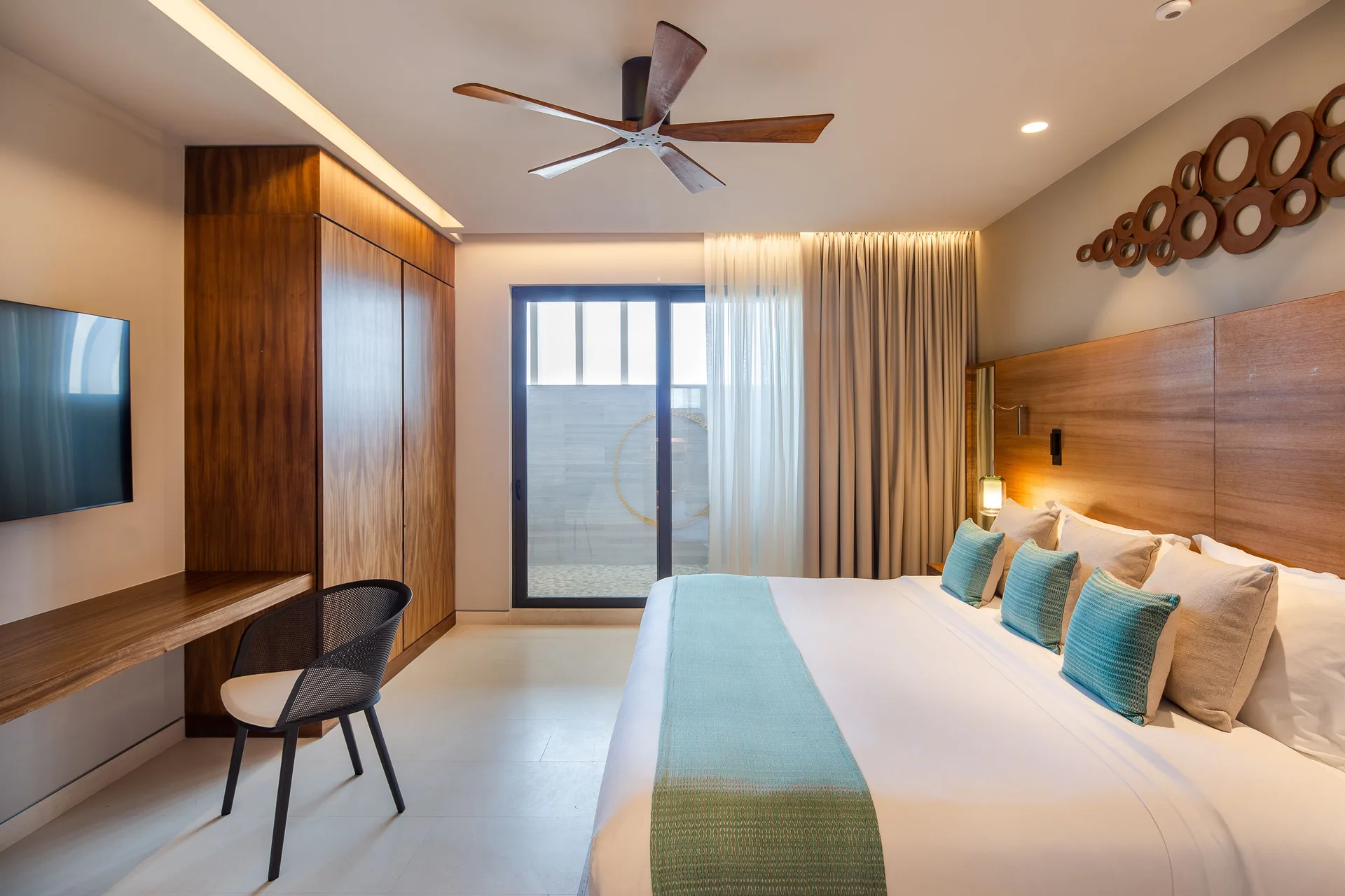 Bedroom in a Three Bedroom Villa Ocean View at The Club at Solaz with a king bed, desk, TV and terrace doors.