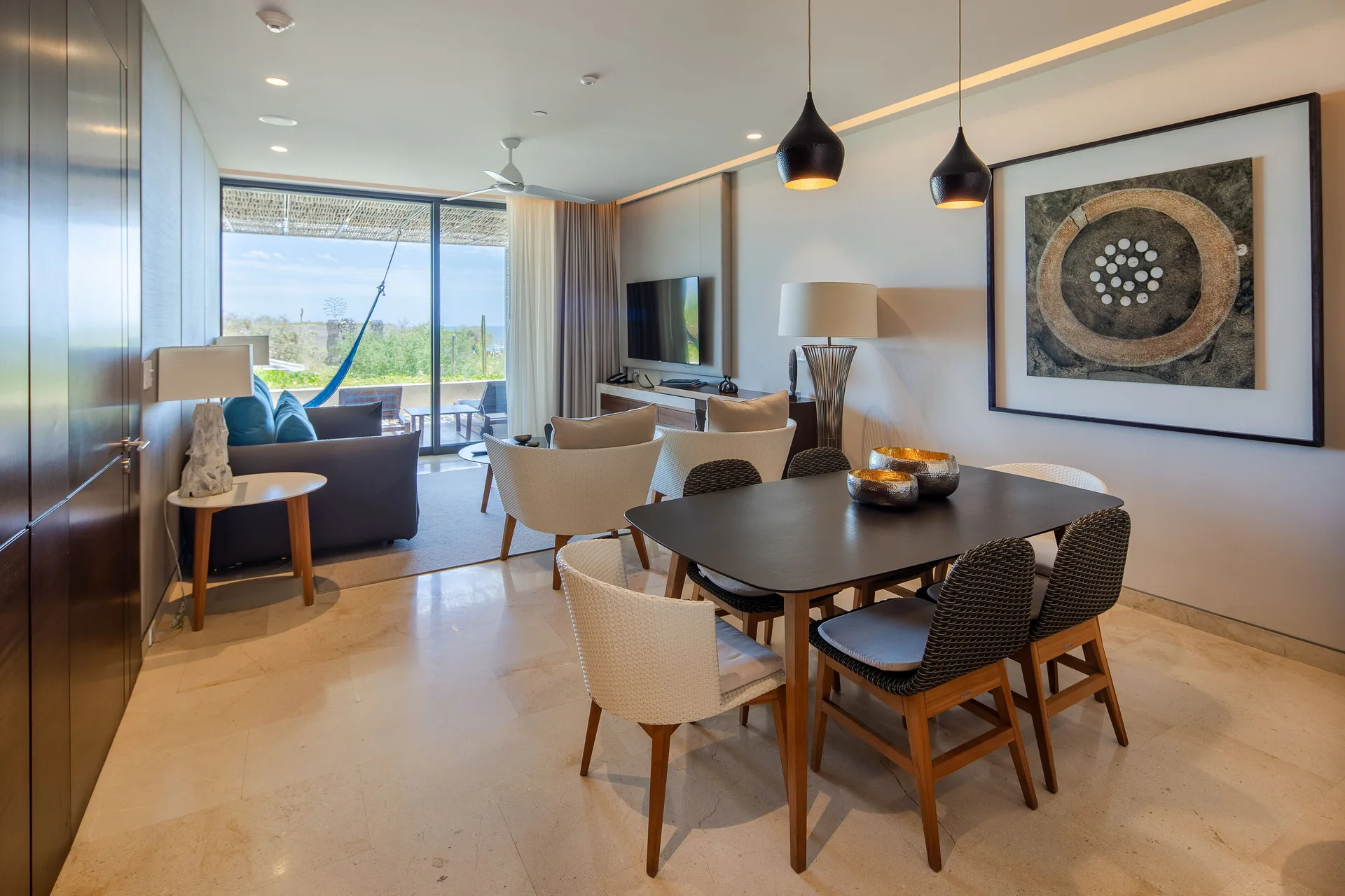 Dining and living area in a Three Bedroom Villa at The Club at Solaz with terrace beyond.