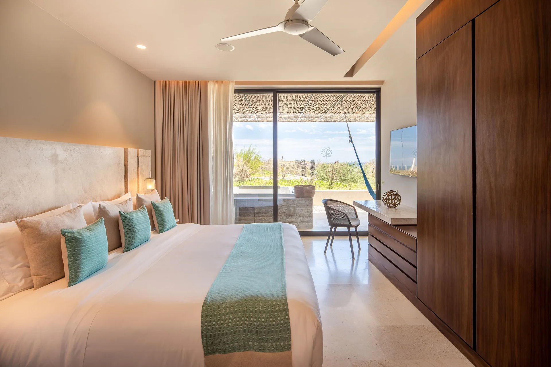 King bedroom in a Three Bedroom Villa at The Club at Solaz with terrace doors and ocean beyond.