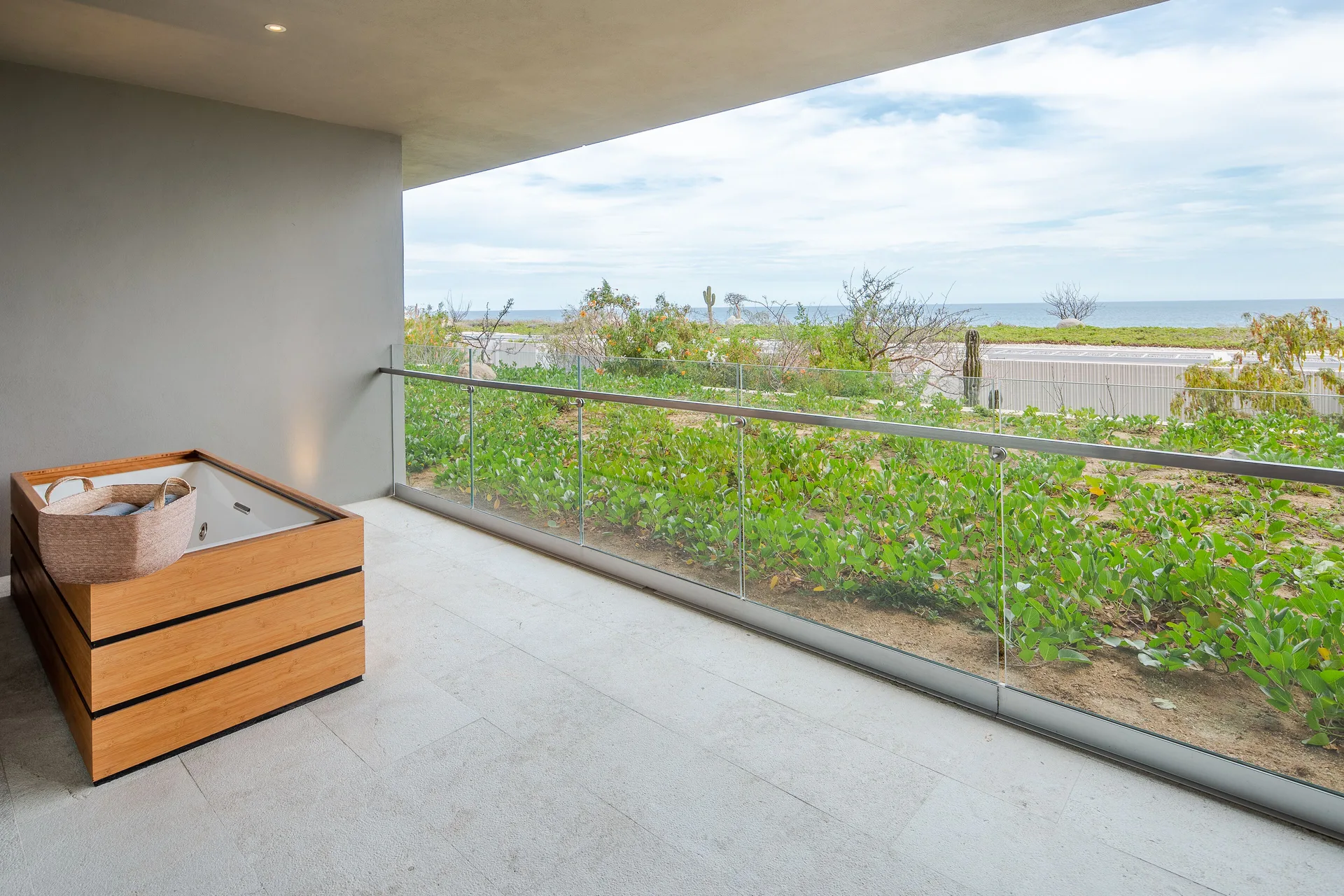 Covered villa balcony with hot tub and ocean view at The Club at Solaz.