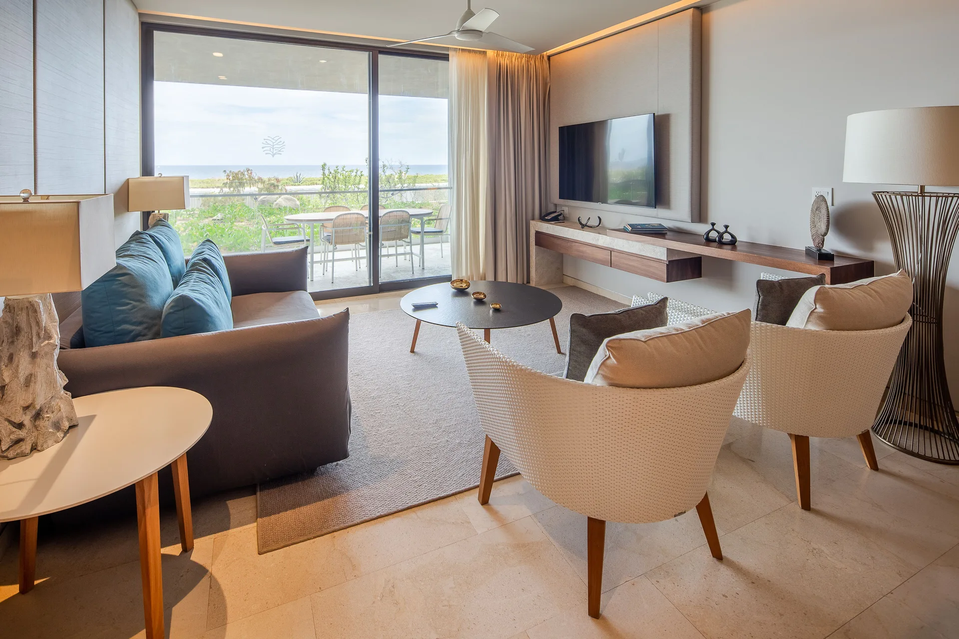 Ocean-view villa living room with balcony seating at The Club at Solaz.
