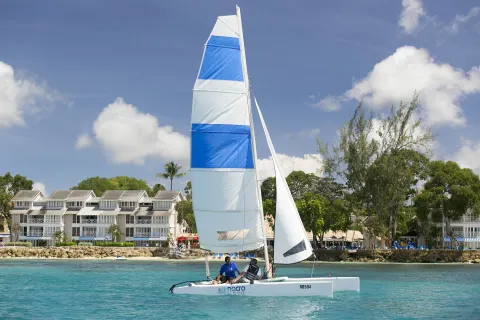 Catamaran sailing near the beachfront at The Club, Barbados Resort & Spa.