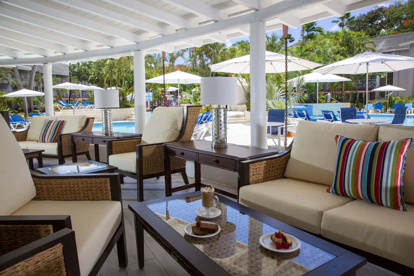 Covered poolside lounge seating at The Club, Barbados Resort & Spa.