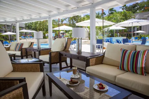 Covered poolside lounge seating at The Club, Barbados Resort & Spa.